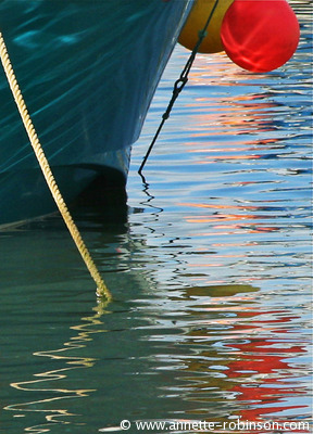Buoys, a boat and reflections